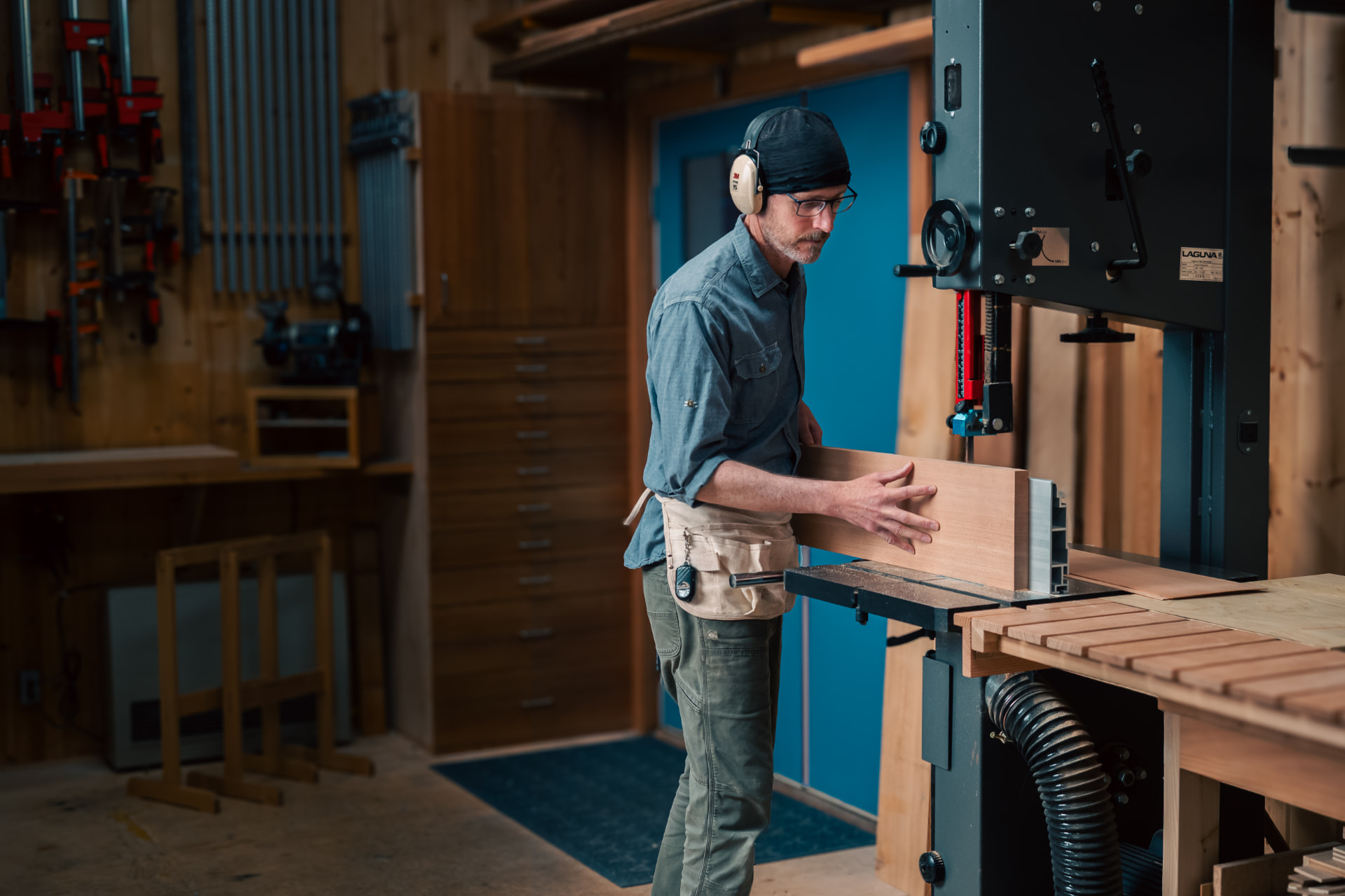 Laël Gordon working at the bandsaw in his woodworking shop